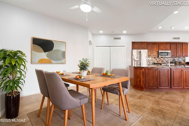 dining area with recessed lighting, a ceiling fan, visible vents, and arched walkways