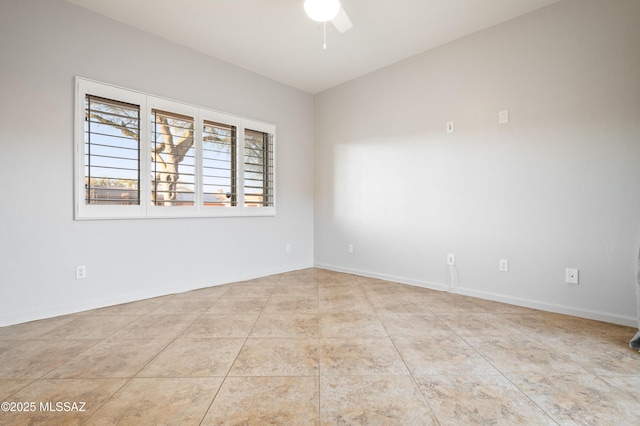 unfurnished room with baseboards, ceiling fan, and tile patterned flooring