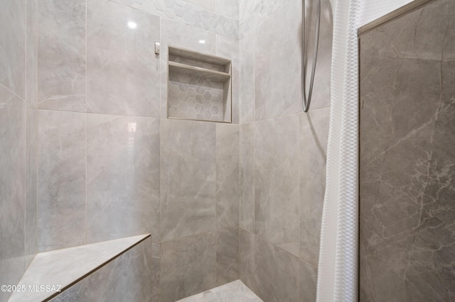 bathroom with a tile shower