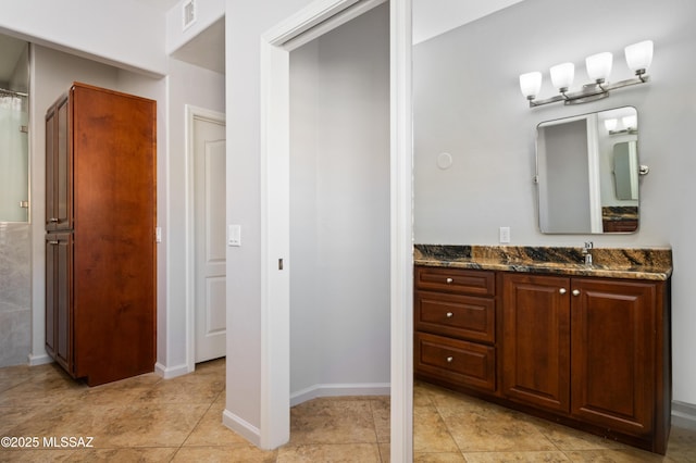 bathroom with visible vents, vanity, and tile patterned flooring