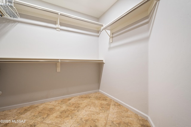 spacious closet featuring tile patterned floors