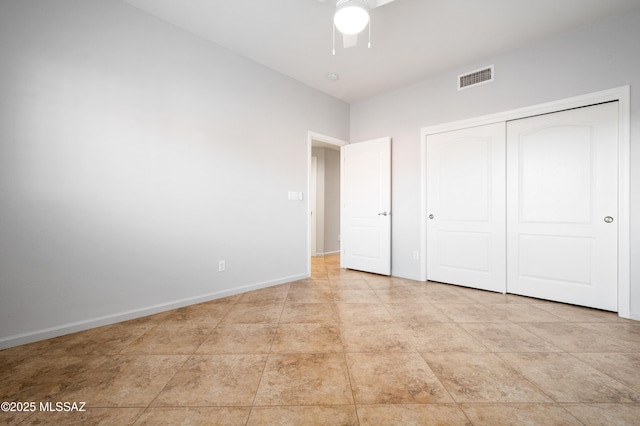 unfurnished bedroom featuring baseboards, visible vents, a closet, and ceiling fan