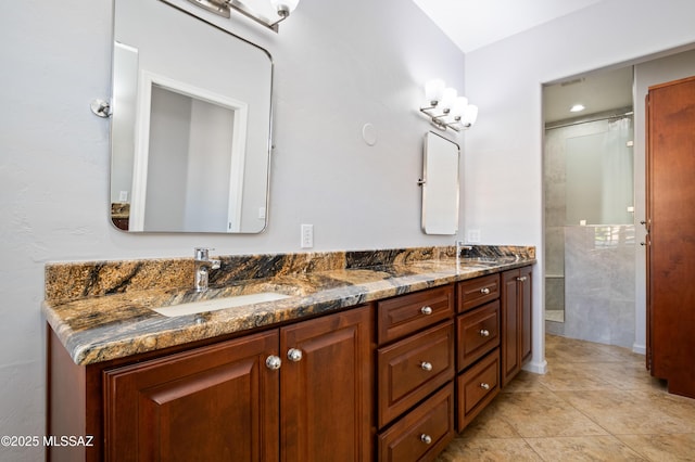 full bathroom with tile patterned flooring, double vanity, a shower, and a sink