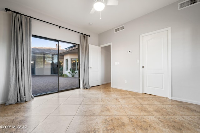 unfurnished room with light tile patterned floors, visible vents, baseboards, and ceiling fan