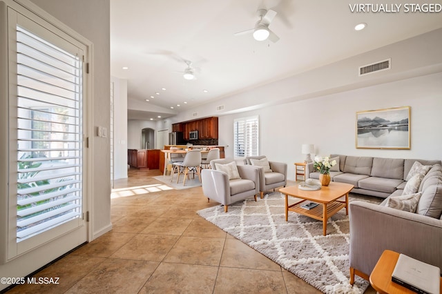 living area featuring visible vents, ceiling fan, lofted ceiling, recessed lighting, and light tile patterned flooring