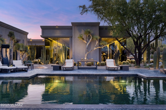 3978 N Canyon Ranch Dr, Tucson, AZ 85750 - back of house featuring a patio area, an outdoor pool, and stucco siding