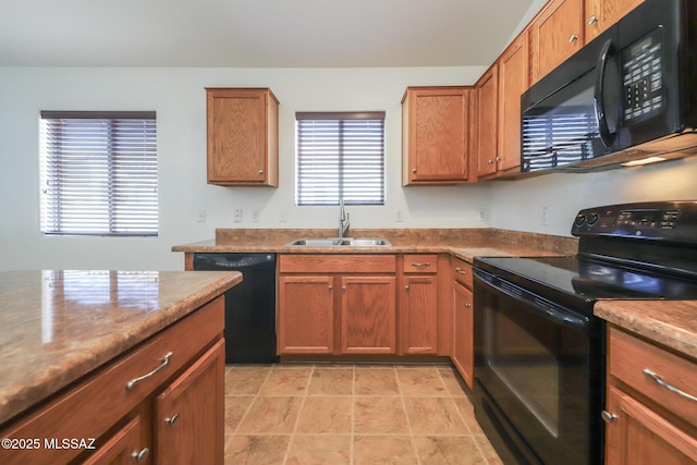 kitchen featuring a sink, black appliances, and brown cabinetry