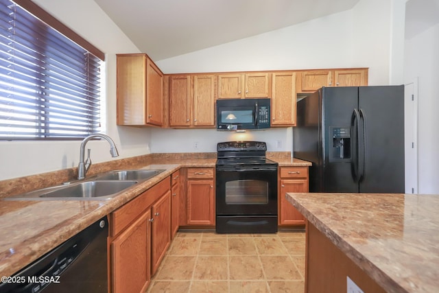 kitchen with black appliances, a sink, brown cabinetry, light countertops, and vaulted ceiling