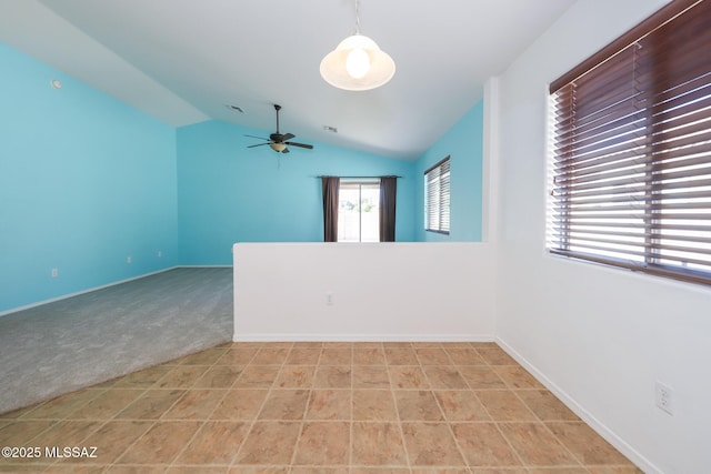unfurnished room featuring visible vents, baseboards, ceiling fan, lofted ceiling, and light carpet