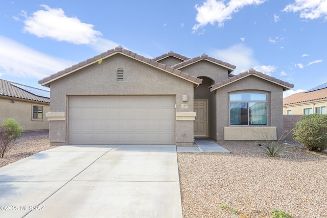 ranch-style home with stucco siding, an attached garage, driveway, and a tiled roof