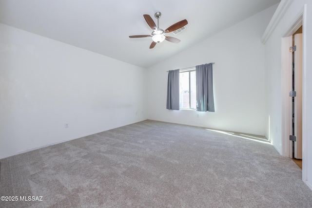 unfurnished room with carpet, lofted ceiling, a ceiling fan, and visible vents