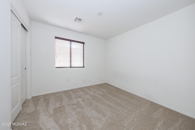 unfurnished bedroom with visible vents, baseboards, carpet, and a closet