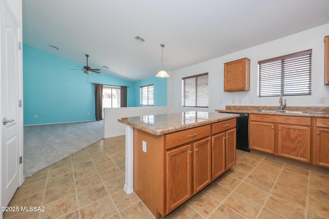 kitchen featuring ceiling fan, dishwasher, light carpet, brown cabinetry, and a sink
