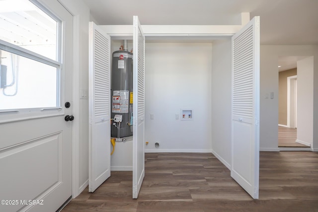 laundry room featuring washer hookup, laundry area, wood finished floors, and water heater