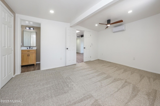 unfurnished bedroom featuring a wall mounted air conditioner, beam ceiling, carpet, and recessed lighting