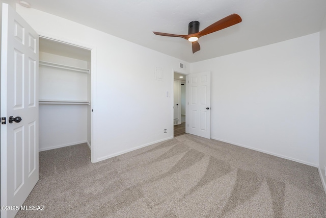 unfurnished bedroom featuring carpet flooring, visible vents, baseboards, and a closet