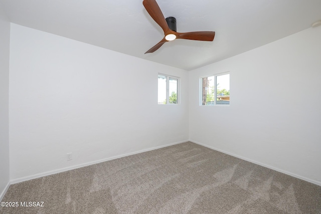 carpeted spare room featuring baseboards