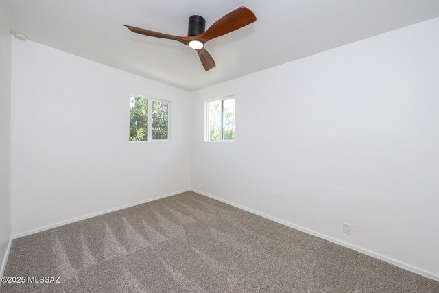 unfurnished room featuring carpet flooring, ceiling fan, lofted ceiling, and baseboards