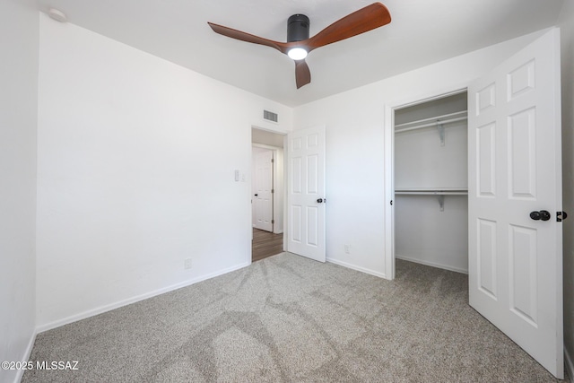 unfurnished bedroom with visible vents, a ceiling fan, a closet, carpet, and baseboards