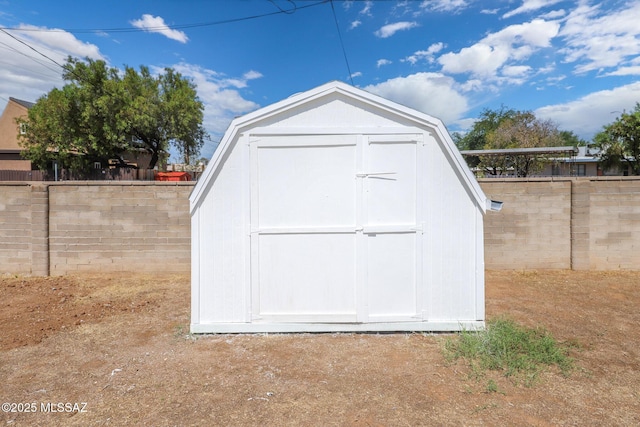 view of shed with a fenced backyard