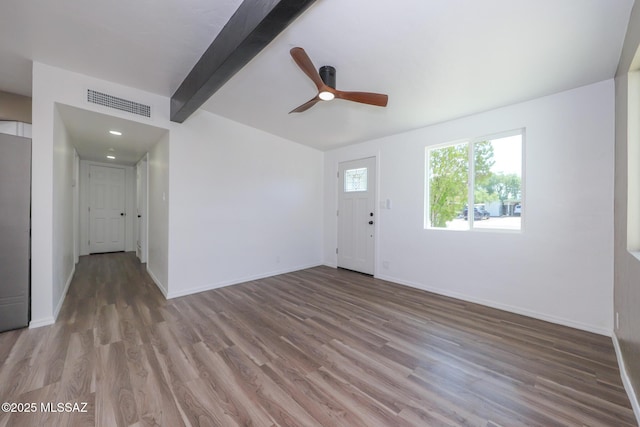 entryway featuring beam ceiling, wood finished floors, visible vents, and baseboards