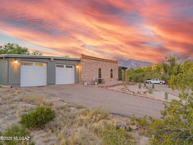 mid-century inspired home with driveway and a garage