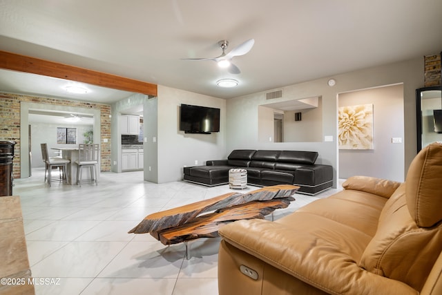 living area featuring a ceiling fan and visible vents