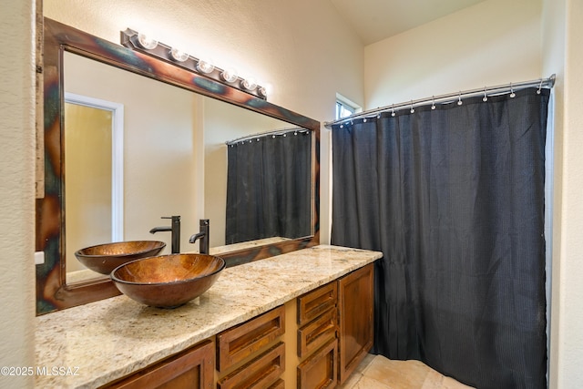 full bathroom with vanity and tile patterned flooring