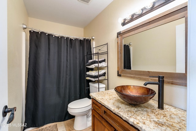 bathroom featuring visible vents, toilet, vanity, and a shower with curtain