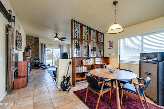 dining room featuring vaulted ceiling, light tile patterned floors, and a ceiling fan