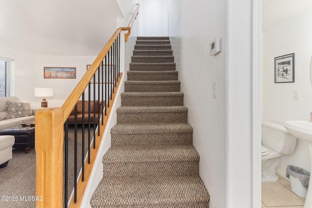 staircase featuring tile patterned floors