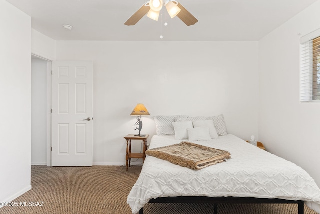 carpeted bedroom with a ceiling fan and baseboards