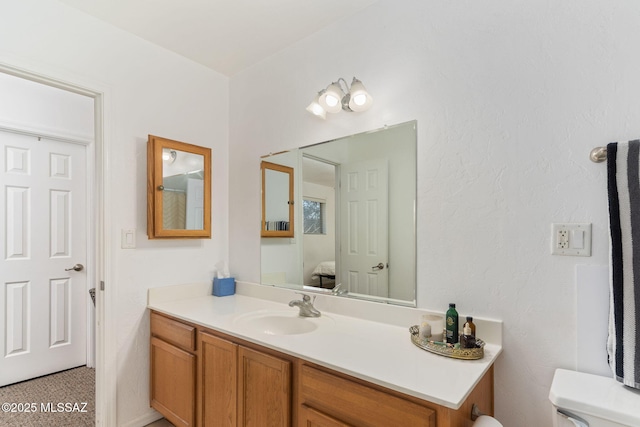 bathroom with toilet and vanity