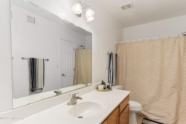 bathroom with visible vents, toilet, a baseboard heating unit, and vanity