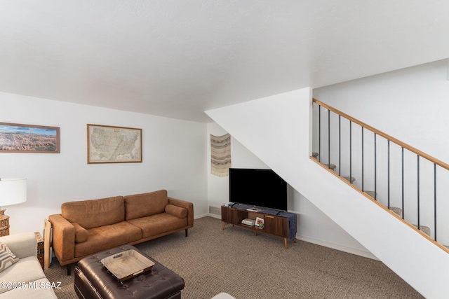 living area featuring stairs, baseboards, and carpet floors