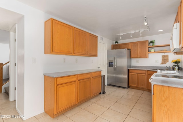 kitchen with light countertops, light tile patterned floors, stainless steel refrigerator with ice dispenser, electric range, and open shelves