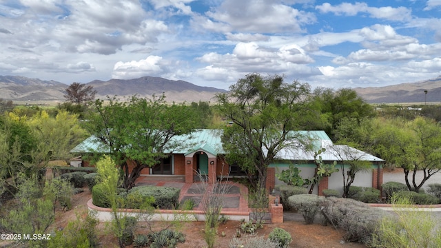 view of front of home featuring a mountain view and brick siding