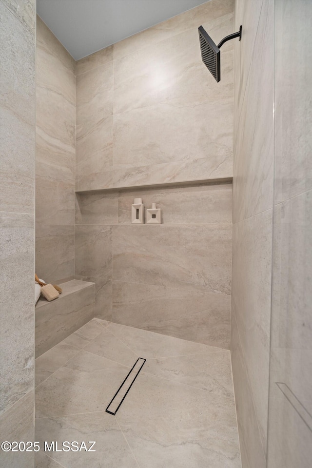 full bath featuring a tile shower