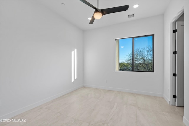 spare room featuring visible vents, plenty of natural light, a ceiling fan, and baseboards