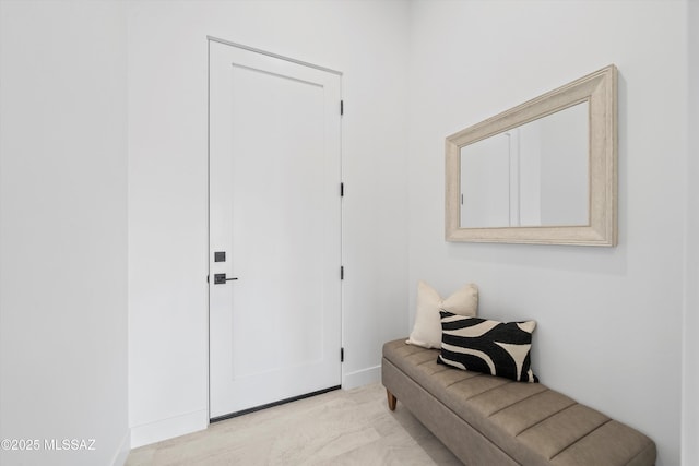 entryway featuring light colored carpet