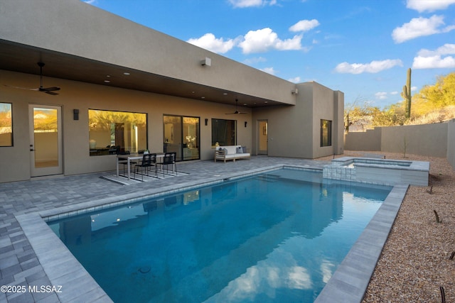 view of swimming pool featuring a patio, a fenced backyard, a ceiling fan, and a pool with connected hot tub