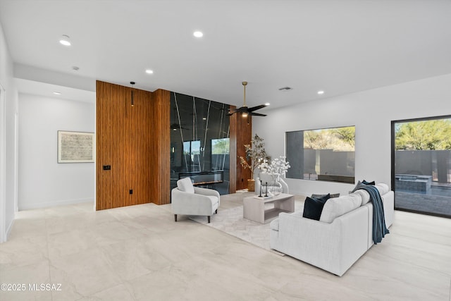 living area featuring visible vents, recessed lighting, and ceiling fan