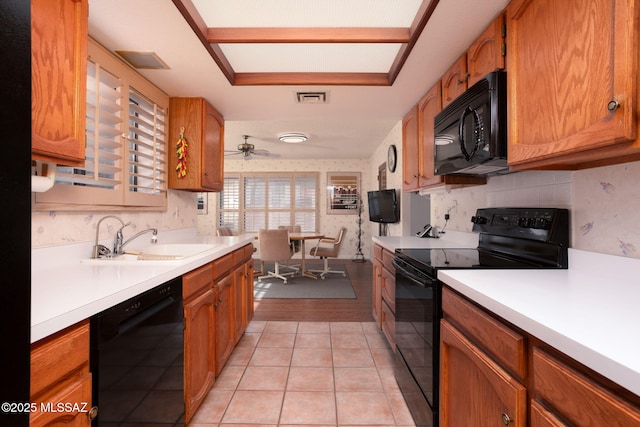 kitchen featuring visible vents, light countertops, light tile patterned flooring, black appliances, and a sink