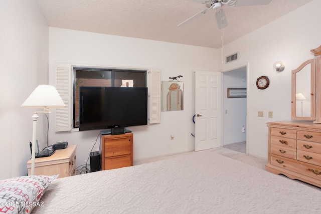 bedroom with visible vents, carpet, ceiling fan, and a textured ceiling