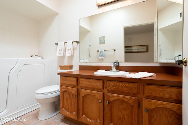 full bathroom featuring vanity, visible vents, tile patterned floors, toilet, and a bathtub