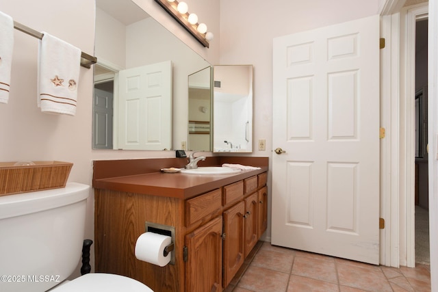 bathroom featuring tile patterned floors, toilet, and vanity