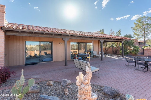 view of patio with outdoor dining space and fence