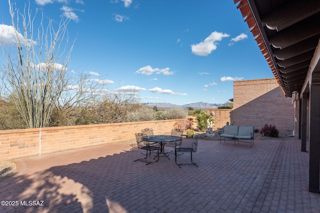 view of patio / terrace with a mountain view and outdoor dining space