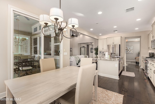 dining area featuring visible vents, baseboards, a chandelier, recessed lighting, and dark wood-style flooring