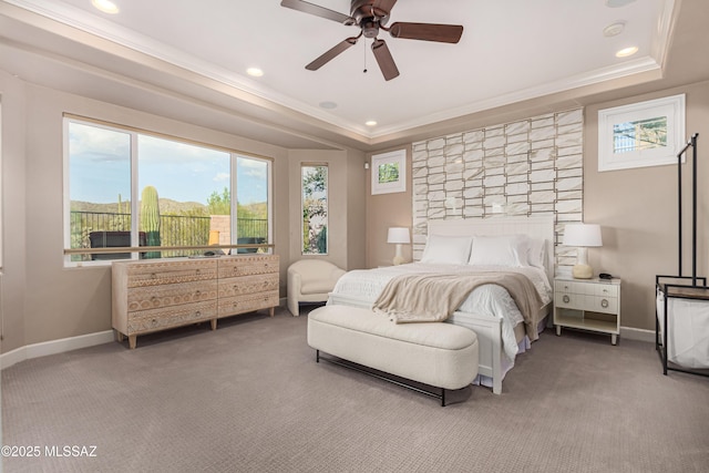 bedroom featuring carpet flooring, crown molding, a raised ceiling, and baseboards